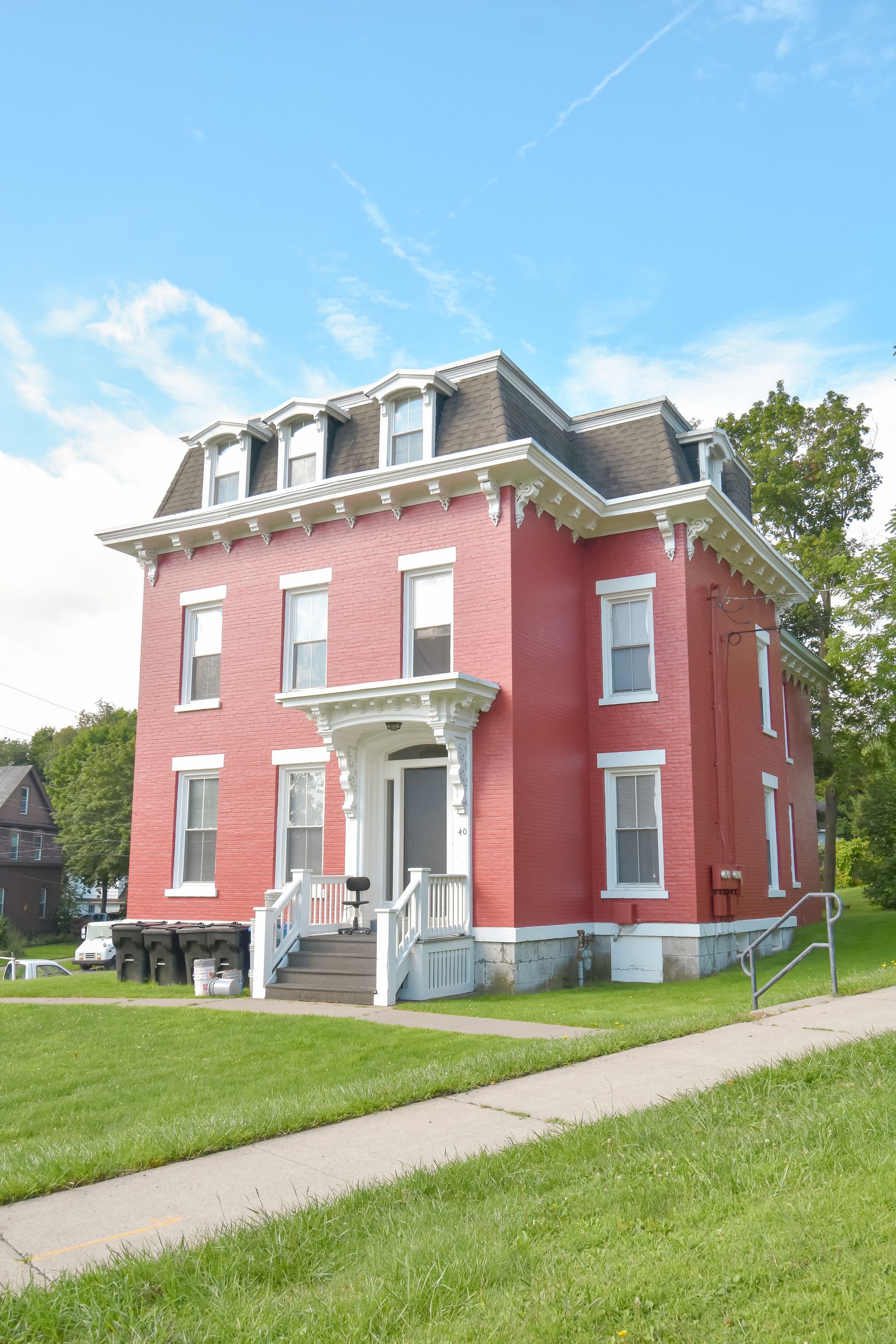 40 Prospect – Large red brick historic-style building with decorative white trim and front steps.