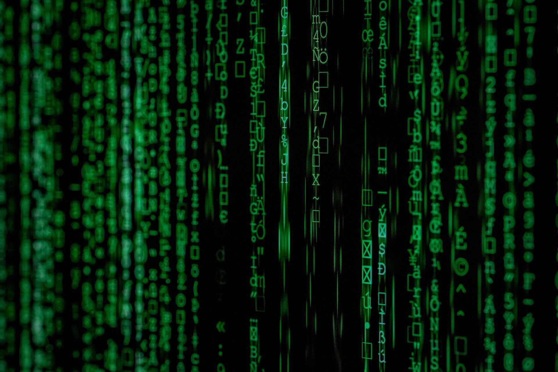 Green digital code streams down a black background.