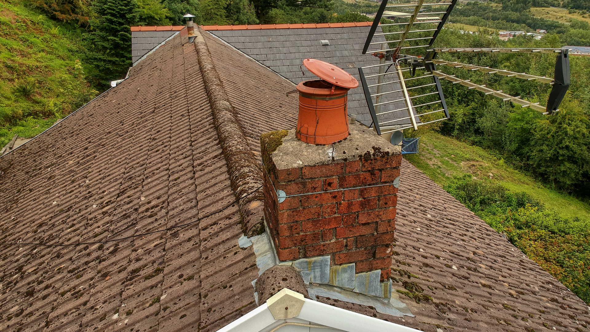 An aerial view of a roof with a chimney on it.