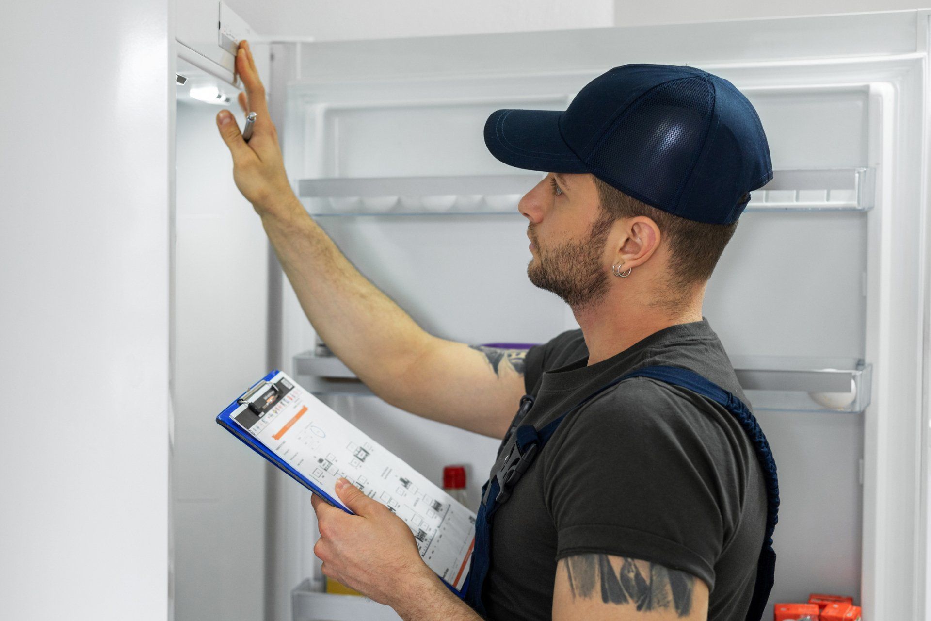 Young Technician Checking Refrigerator - Kallangar, QLD - The Chill Dude