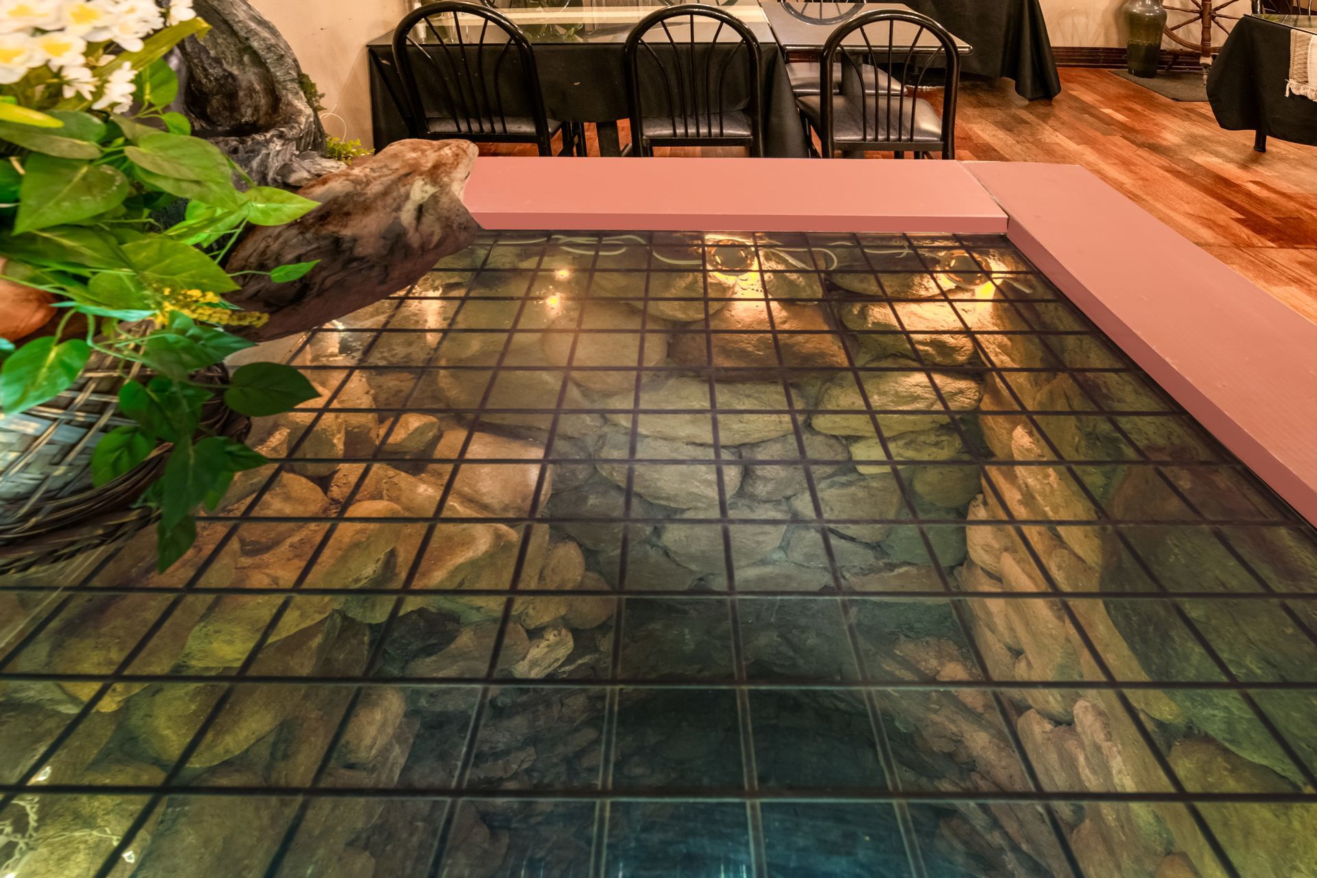 A dining room with tables and chairs and a tiled floor