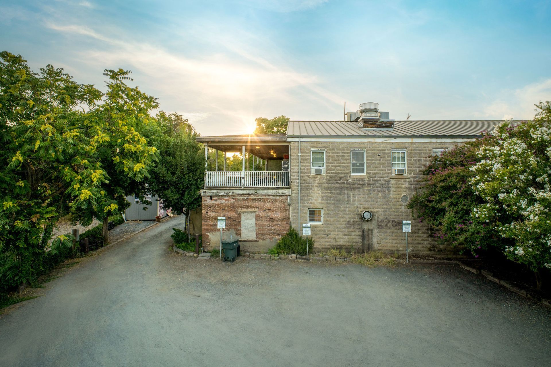 An aerial view of a large brick building surrounded by trees.
