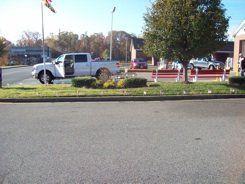 A white truck is parked on the side of the road