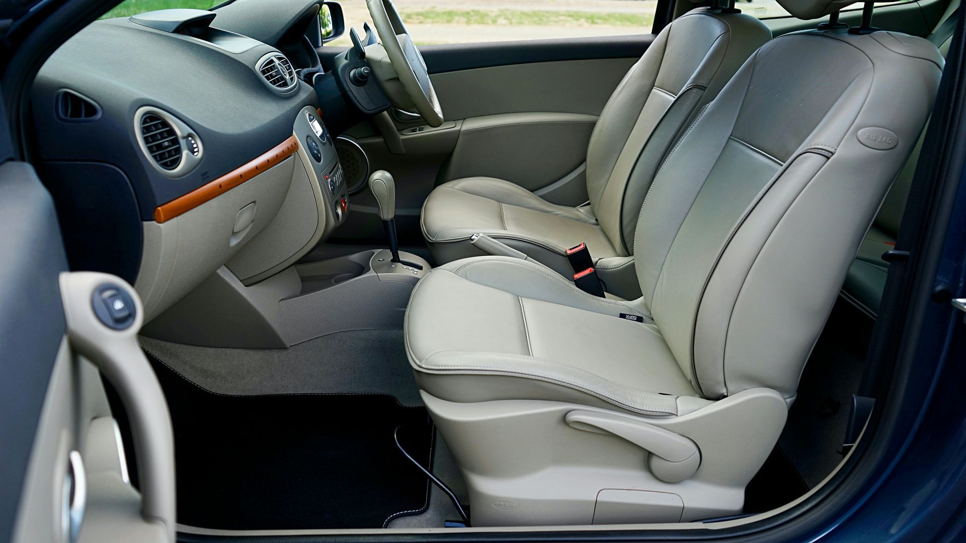 The interior of a blue car with the door open