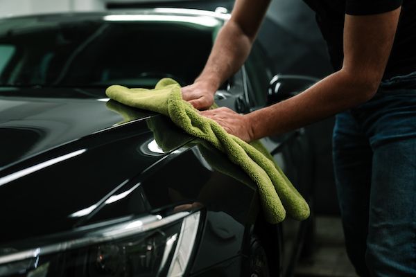hand drying car at a car wash