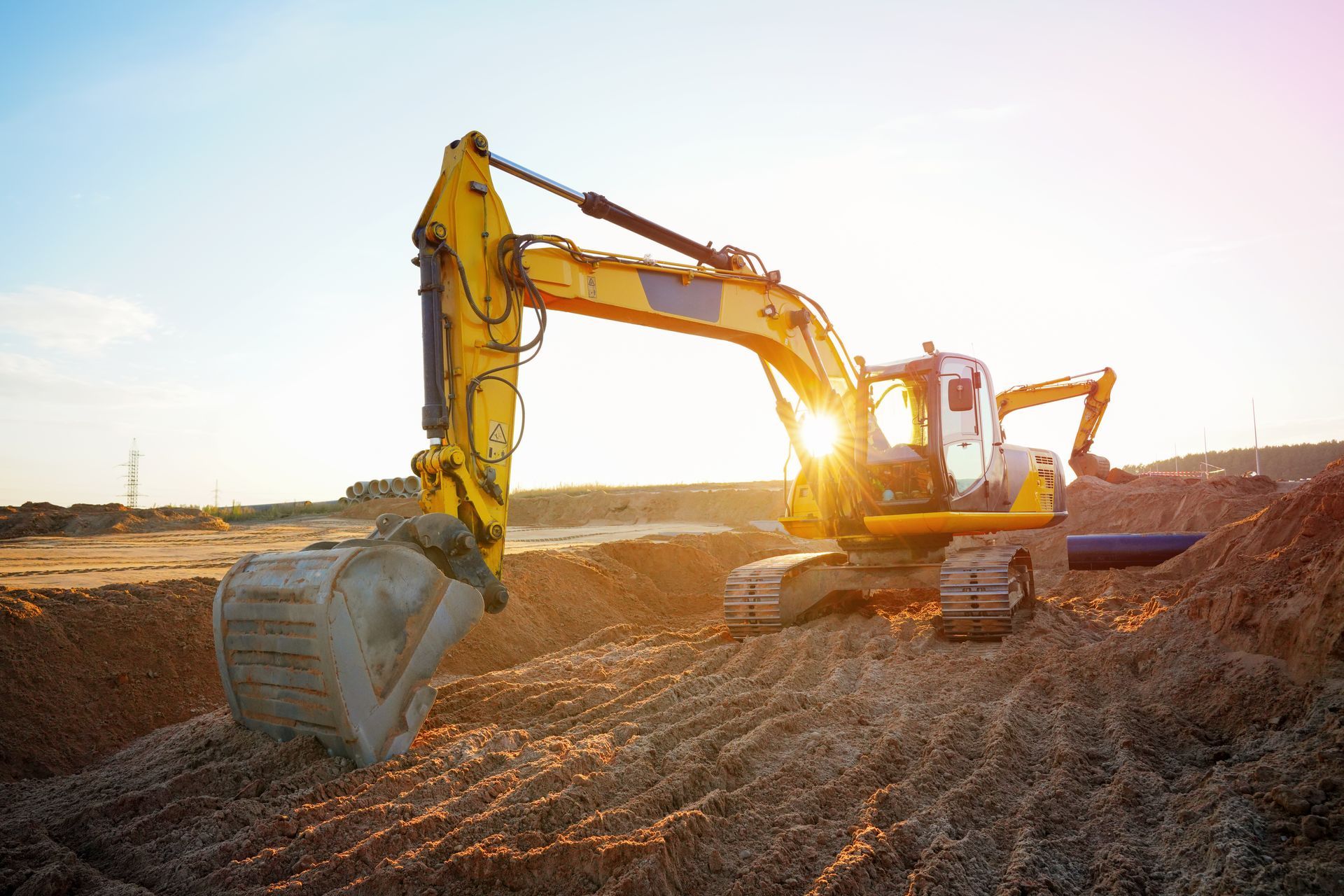 Excavator earthworks on a construction site for a sewerage line repair.