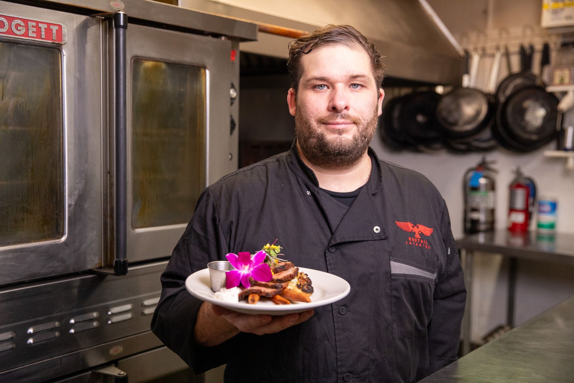 chef holding plate of food