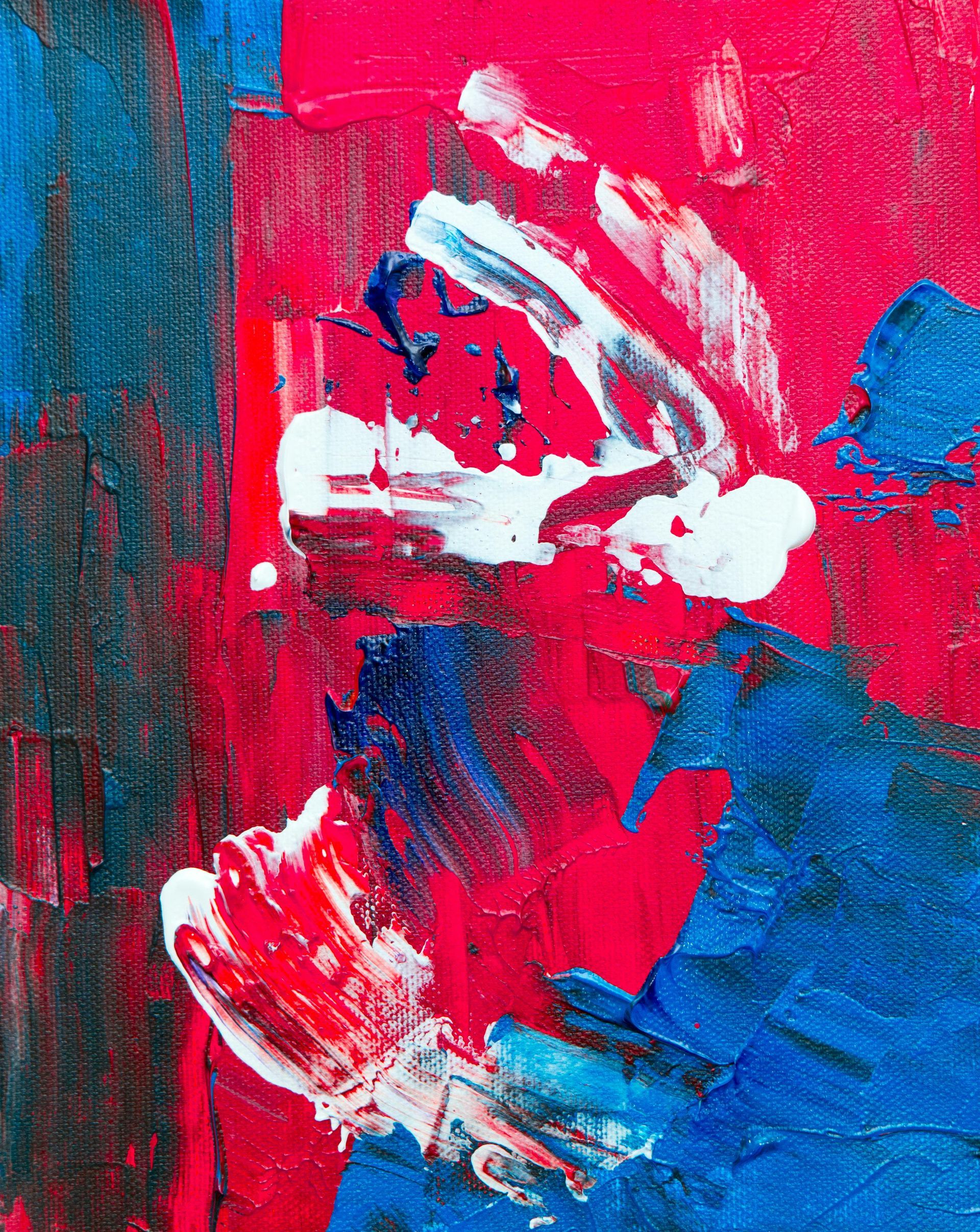 Abstract oil painting featuring thick, textured strokes of vibrant red, deep blue, and white paint.