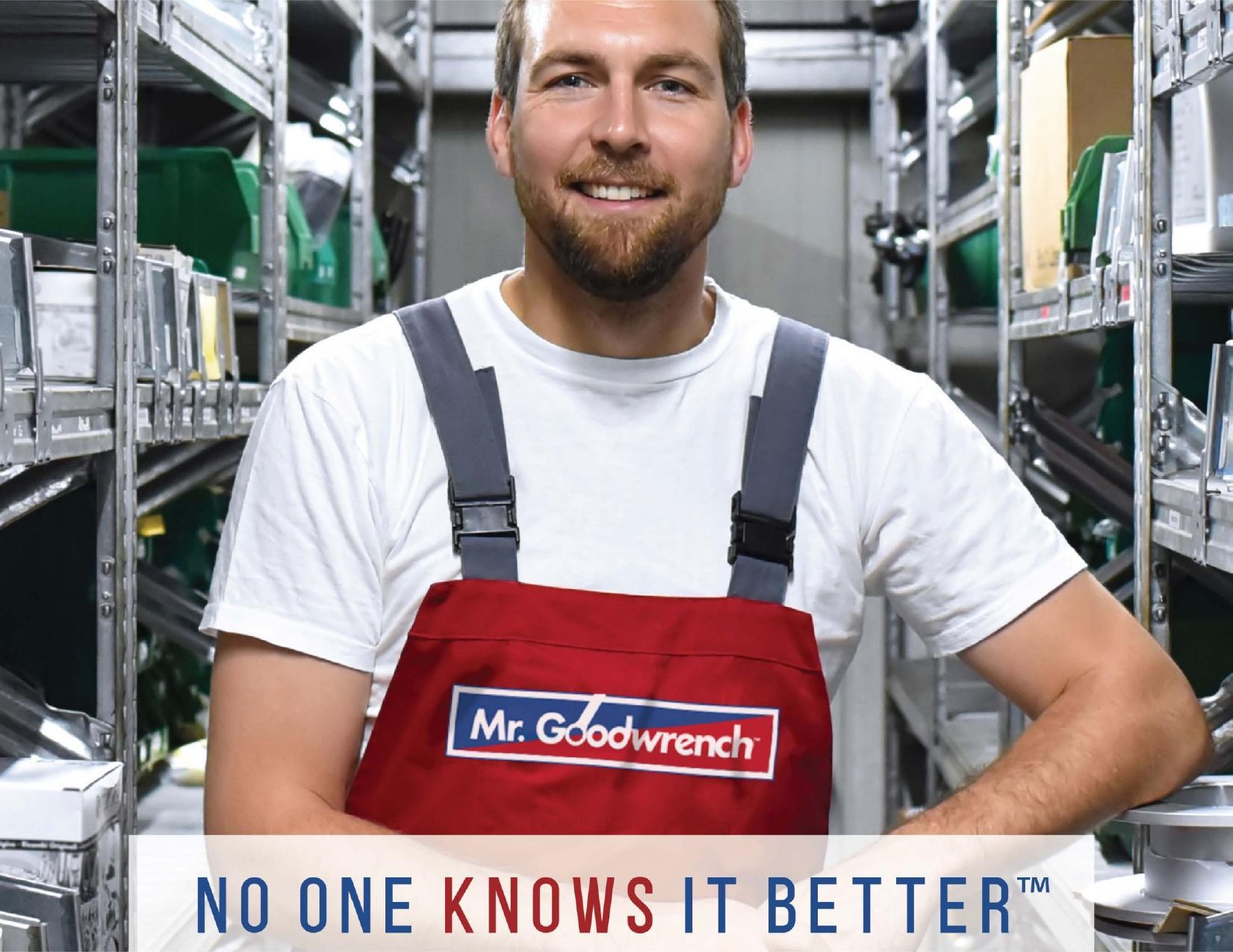 A smiling technician in a red Mr. Goodwrench apron stands in a parts warehouse. Text overlay: NO ONE KNOWS IT BETTER.