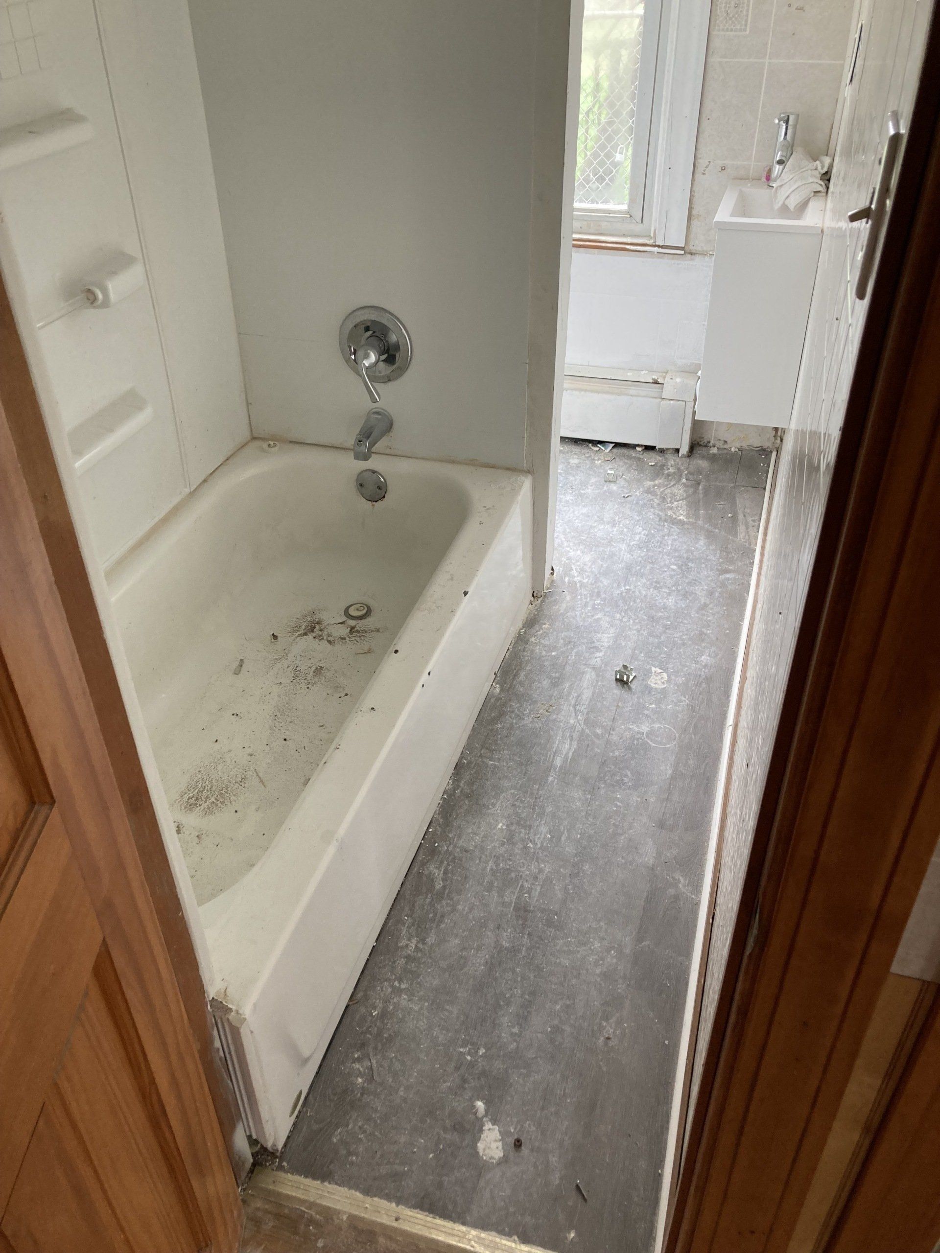 A bathroom with a bathtub and a sink in it.