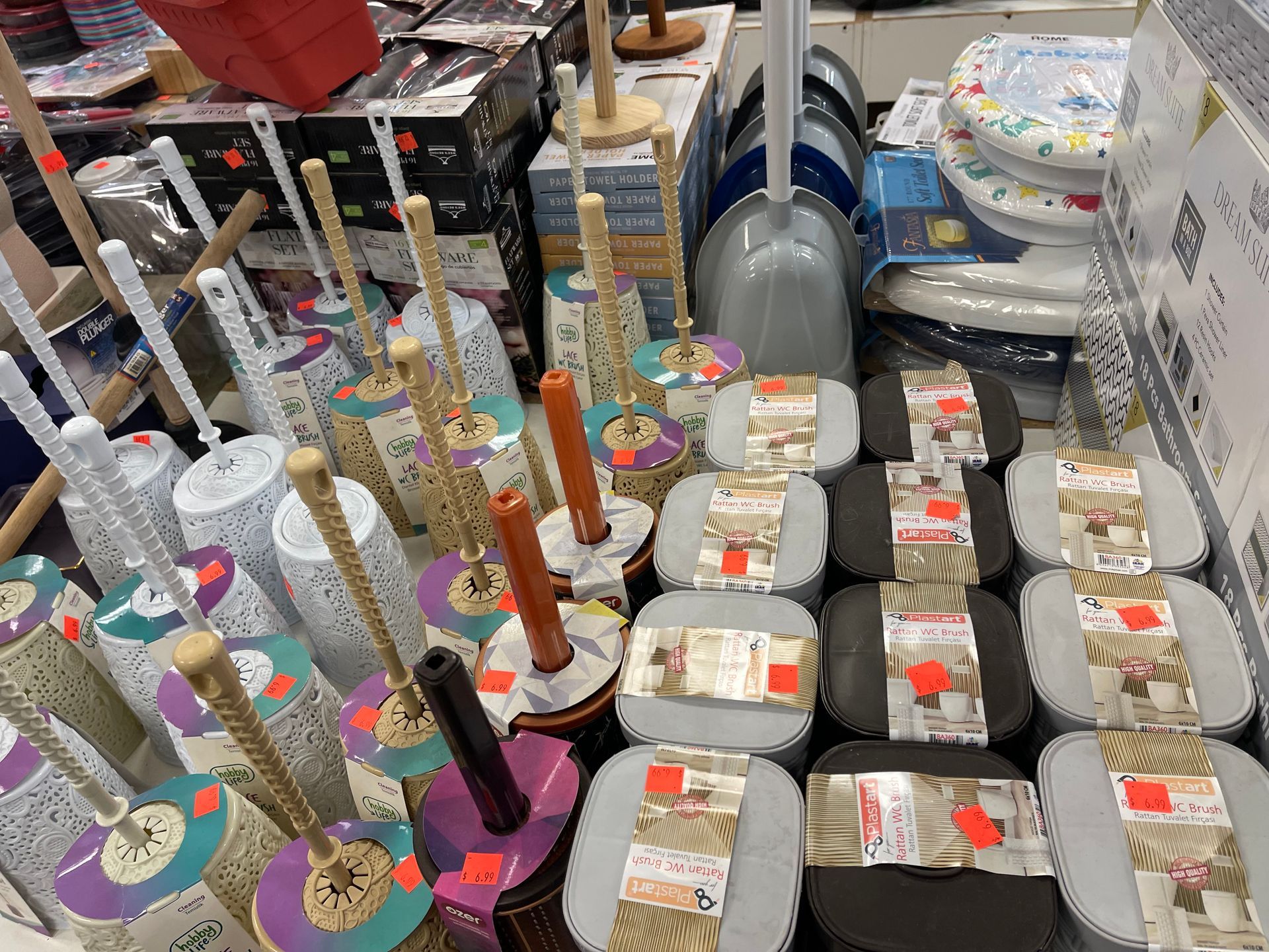 A bunch of toilet brushes are sitting on a table in a store.