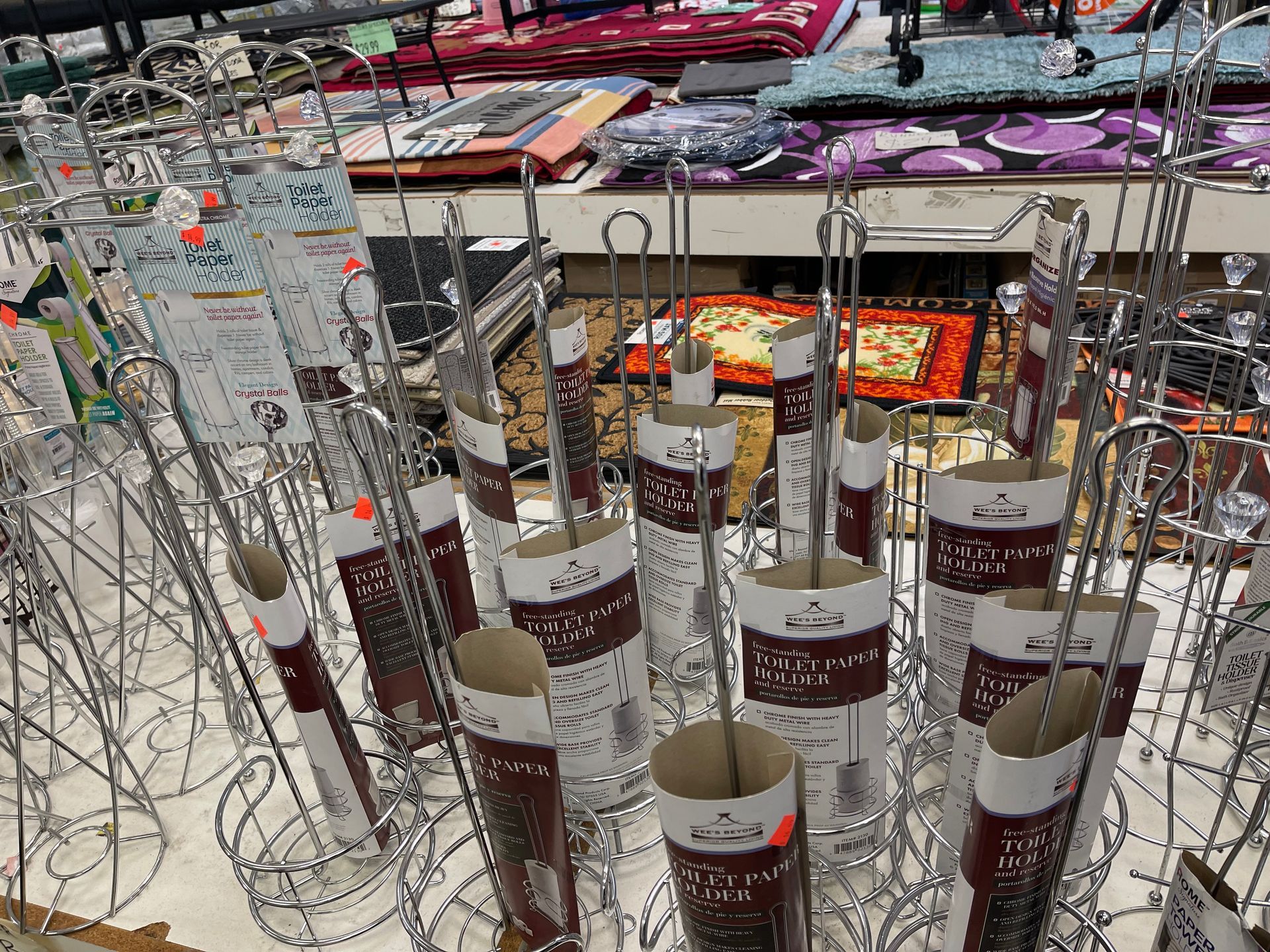A bunch of umbrella holders are sitting on top of each other in a store.