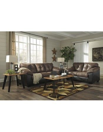 A living room with two couches , a coffee table , and a rug.
