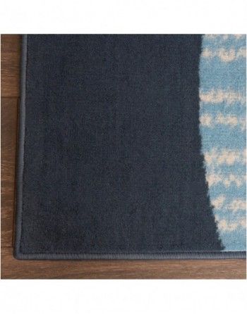 A close up of a rug on a wooden floor.