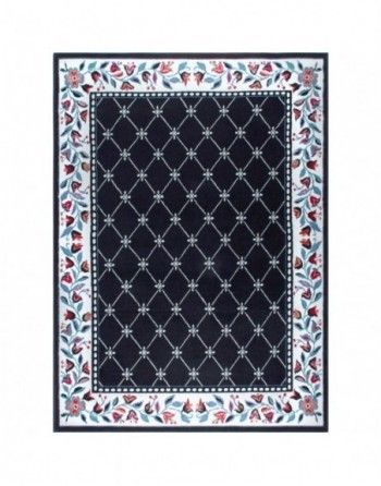 A black rug with flowers and leaves on it