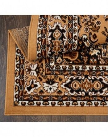 A rug with a floral pattern is laying on a wooden floor.