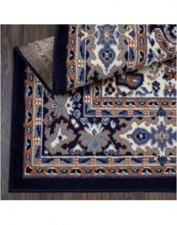 A rug with a floral pattern is laying on a wooden floor.