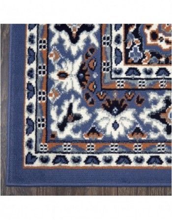 A blue rug with a floral pattern on it