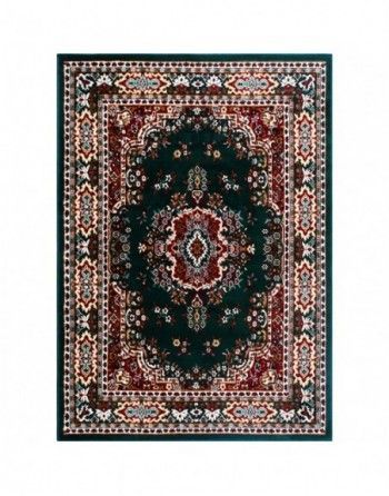 A green rug with a red and white pattern on it.