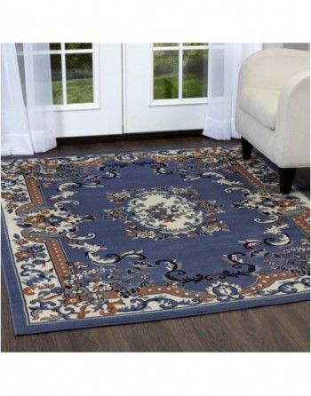 A blue rug is on the floor in a living room