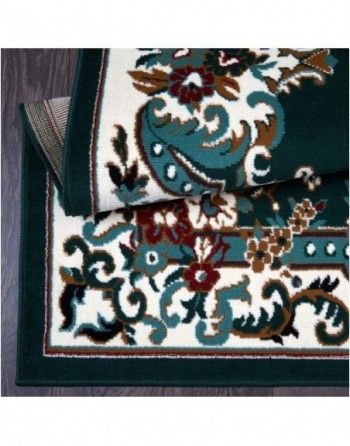 A green and white rug with a floral pattern on it
