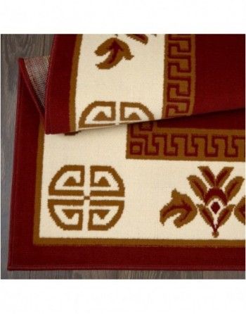 A red and white rug with a greek key design