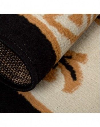 A close up of a rug with a black and tan pattern