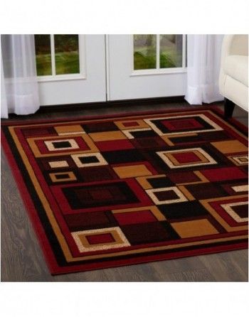 A red rug with squares on it is in a living room