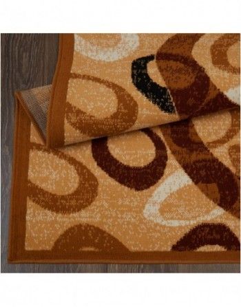 A rug with circles on it is laying on a wooden floor.
