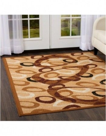 A rug is sitting on the floor in a living room next to a couch.
