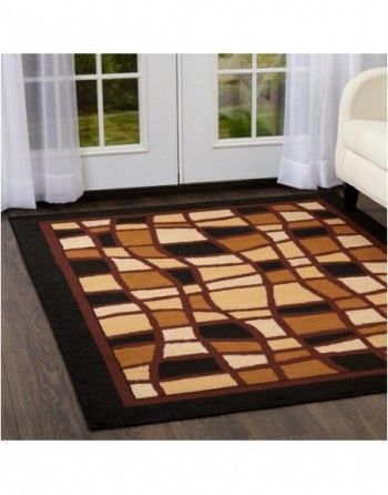 A brown rug with a black border is in a living room