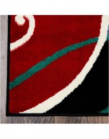A red and black rug with a white swirl on it