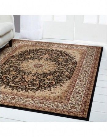A rug is sitting on the floor in a living room next to a couch.