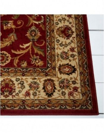 A red rug with a floral pattern on it