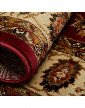 A close up of a rug with a red border