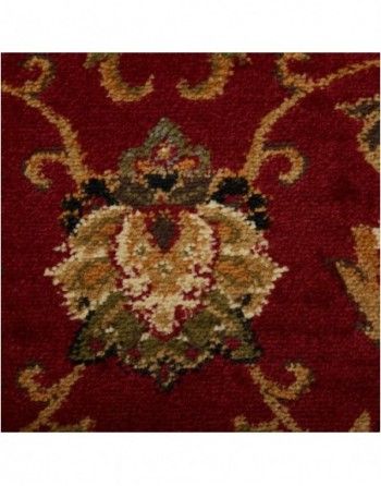 A close up of a red rug with a floral pattern