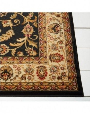 A rug with a black border and a floral pattern
