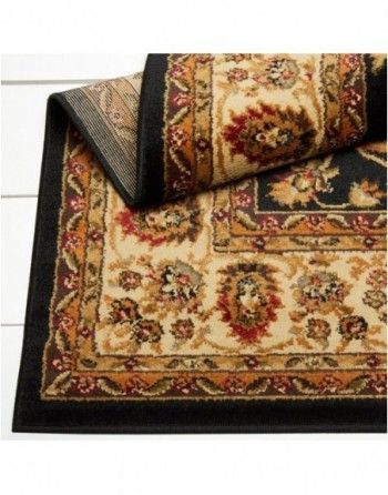 A rug with a black border and a floral pattern