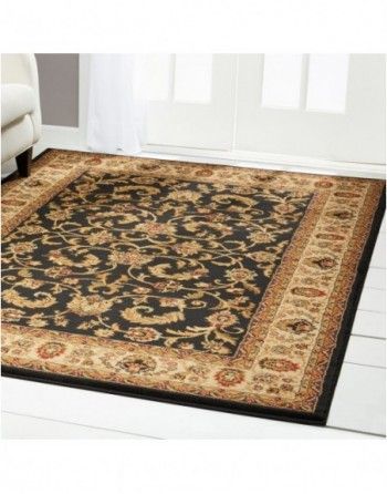 A black and gold rug is on the floor in a living room