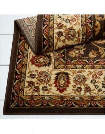 A rug with a brown border and a floral pattern