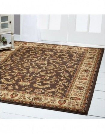 A brown rug is sitting on a white floor in a room