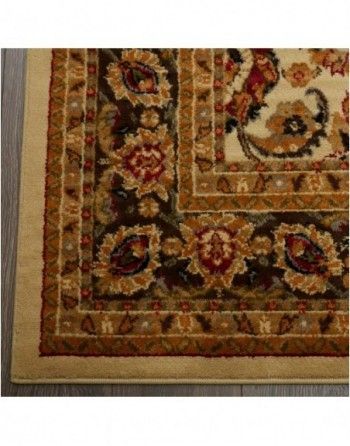 A rug with a floral pattern on it is sitting on a wooden floor.