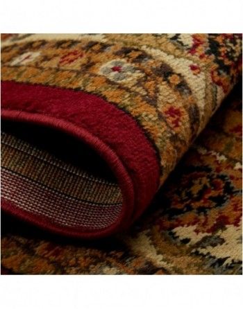 A close up of a rug with a red border