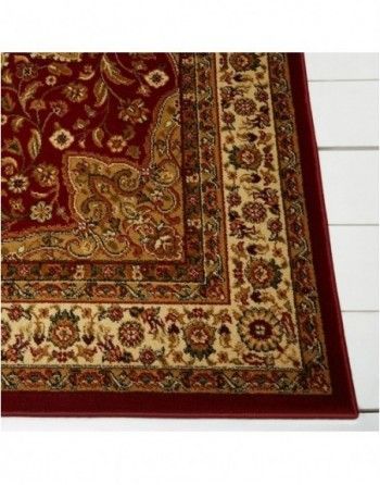 A red rug with a floral pattern on it
