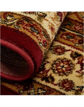 A close up of a rug with a red border