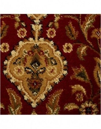 A close up of a red rug with a floral pattern