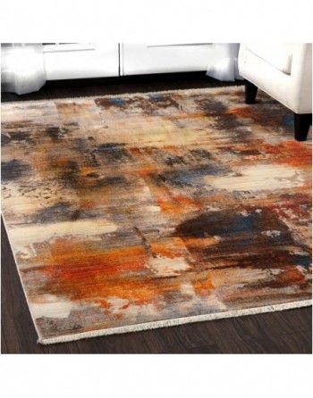 A rug is sitting on a wooden floor in a living room next to a chair.