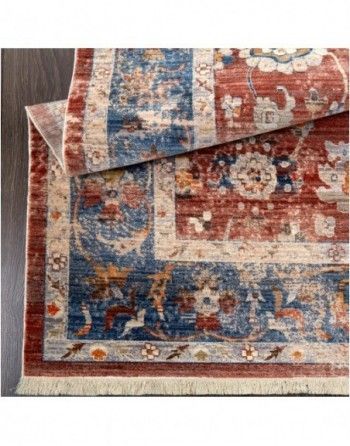 A rug with a floral pattern is sitting on a wooden floor.