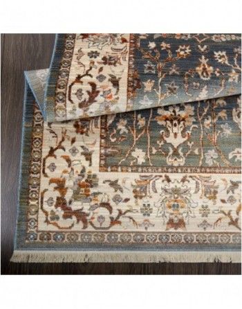 A rug with a floral pattern is sitting on top of a wooden floor.