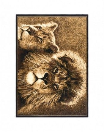 A lion and a lioness are laying next to each other on a rug.